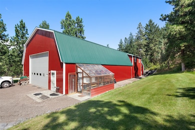 View of greenhouse featuring a lawn and driveway