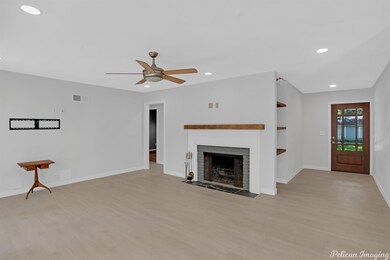 Wood burning fireplace and open concept living roo