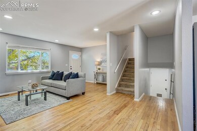 Living room with light hardwood / wood-style floor