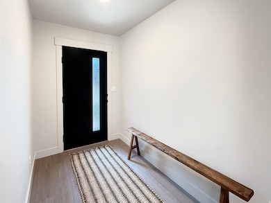 Entryway with light wood-style floors and baseboards