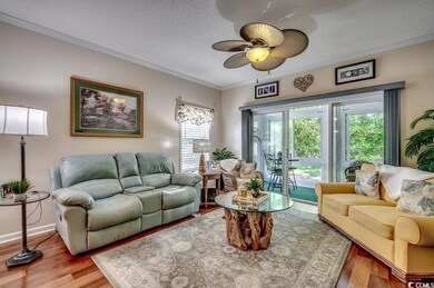 Living room with a textured ceiling, hardwood / wo