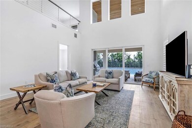Living room featuring a high ceiling, light wood-s