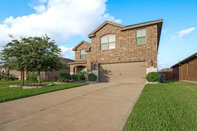 Expanded driveway leads to a stately brick elevati