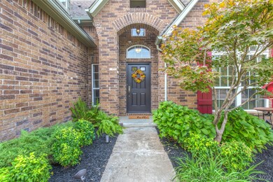 Mature flowerbeds welcome you into this full brick