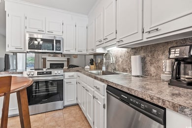 Kitchen featuring tasteful backsplash, appliances 