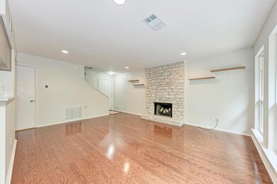 Unfurnished living room featuring a fireplace, wo