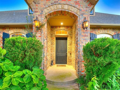 Entrance to property with a shingled roof and brick siding