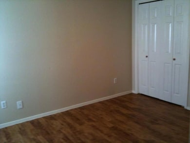 Unfurnished bedroom featuring a closet, baseboard
