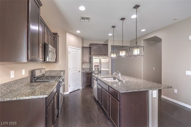 Kitchen featuring stainless steel appliances, a si