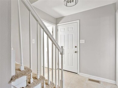 Foyer view of the stairway to the 2nd level and in