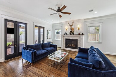 Open living area with high ceilings and gas firepl