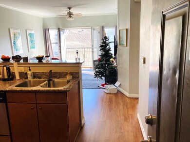 Kitchen featuring a ceiling fan, ornamental moldi