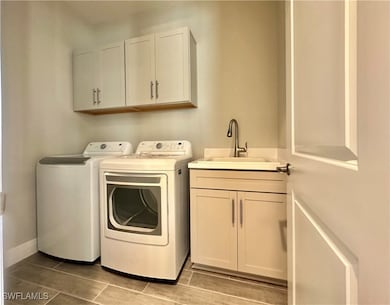 Clothes washing area featuring washer and clothes