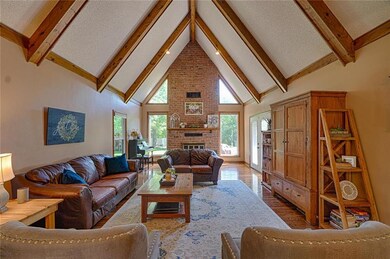Great room has vaulted ceilings, brick fireplace and plenty of natural light.