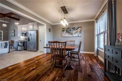 Formal dining room open to  kitchen. Wide painted 