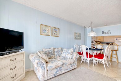 Tiled living room featuring a textured ceiling and
