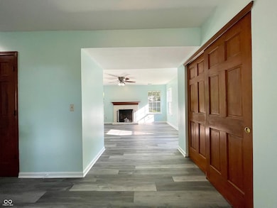 hallway featuring wood finished floors and baseboards