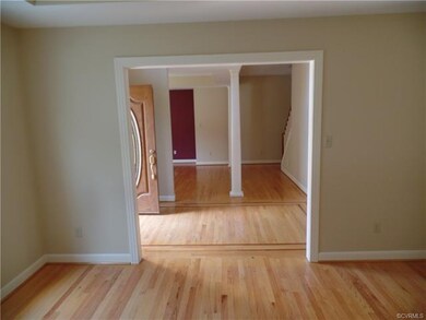 The living room has an oversized doorway and a gre