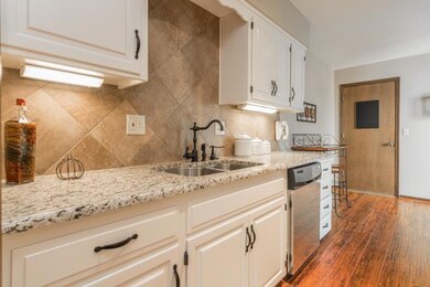 Beautifully updated kitchen offers granite counter
