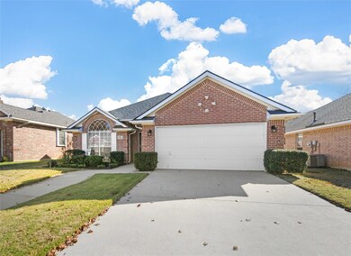 View of front facade with a garage, a front lawn, 