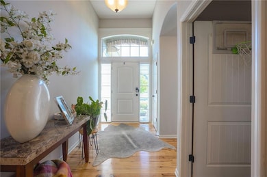 Entrance foyer featuring light wood-style flooring and baseboards