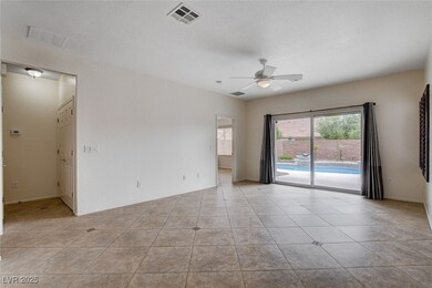 Spare room with visible vents, a ceiling fan, and
