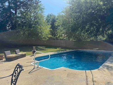 View of swimming pool with a fenced backyard and a patio