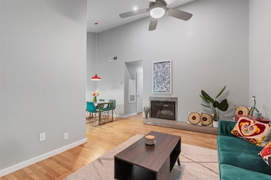 Living room with a towering ceiling, ceiling fan,