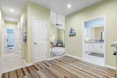 Hall foyer featuring light tile patterned floors, light carpet, and recessed lighting