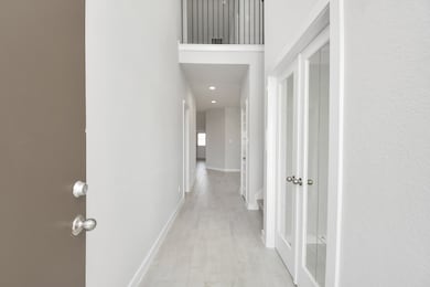 As you step into the threshold of this luxurious home, you'll soon be welcomed by an elegant glass door (to be installed). Inside, soaring ceilings amplify the spaciousness, while the refined wood-look tile flooring and oversized baseboards exude sophistication and charm. Sample photo of completed home with similar floor plan. Actual colors and selections may vary.
