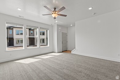 Unfurnished room with carpet flooring, ceiling fan, and recessed lighting