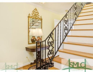 Foyer. Entry foyer with detail stair rail and coat