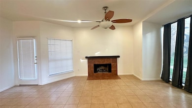 Unfurnished living room featuring a ceiling fan, a