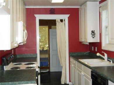 Kitchen. Kitchen leads into half bath and laundry