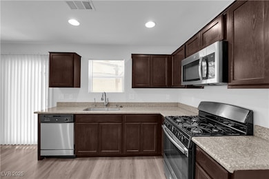 Kitchen featuring stainless steel appliances, dark