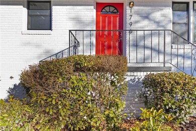 Stunning entrance, red door with brick siding