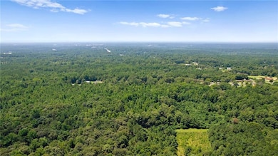 Birds eye view of property featuring a view of tre