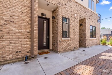 Property entrance featuring brick siding