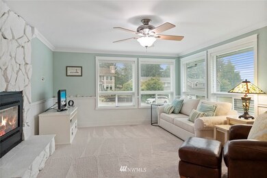 Front family room with gas fireplace, new carpet and lots of natural light.