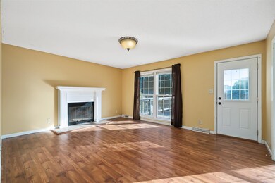 Spacious Living Room w/ a Fireplace! Lots of Storage in the Closet Under the Stairs! 