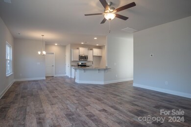 Family Room into Kitchen/Breakfast Area. Photo representation. Colors and options will differ.