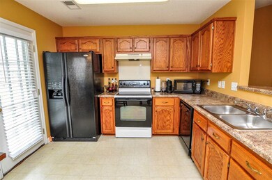 The kitchen comes equipped with an electric range/
