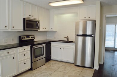 Kitchen featuring stainless steel appliances, dar
