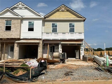 View of front facade featuring brick siding and a garage