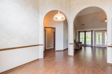Neutral color, laminate flooring, arched entryways