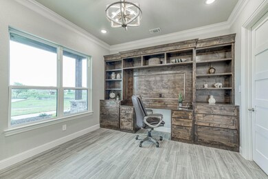 French doors with frosted glass opens to the Impressive office with built-ins, desk, plus stunning views!
