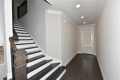 Entrance foyer with ornamental molding, stairs, re