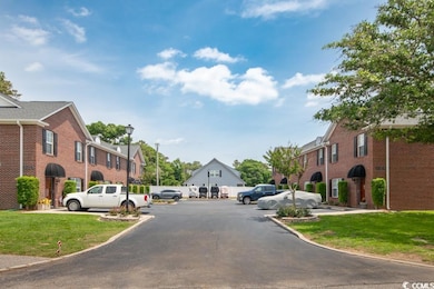 View of asphalt street featuring street lights and