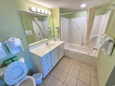 Full bathroom featuring tile patterned flooring, v