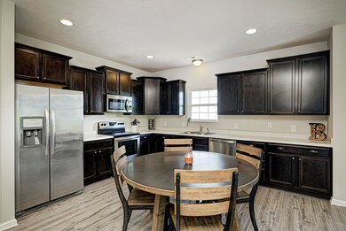 Spacious Eat In Kitchen with Stainless Appliances, Vinyl Plank Floors and Staggered Cabinets